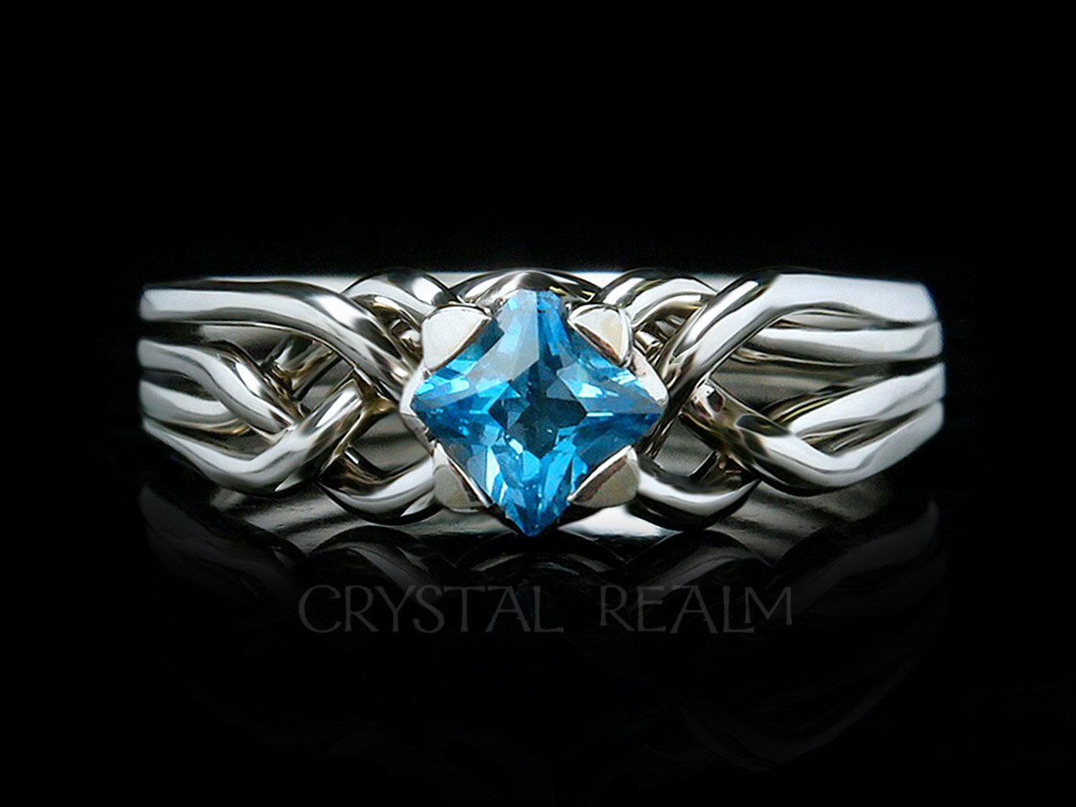 4 piece puzzle ring with princess cut blue topaz and palladium with a medium low setting