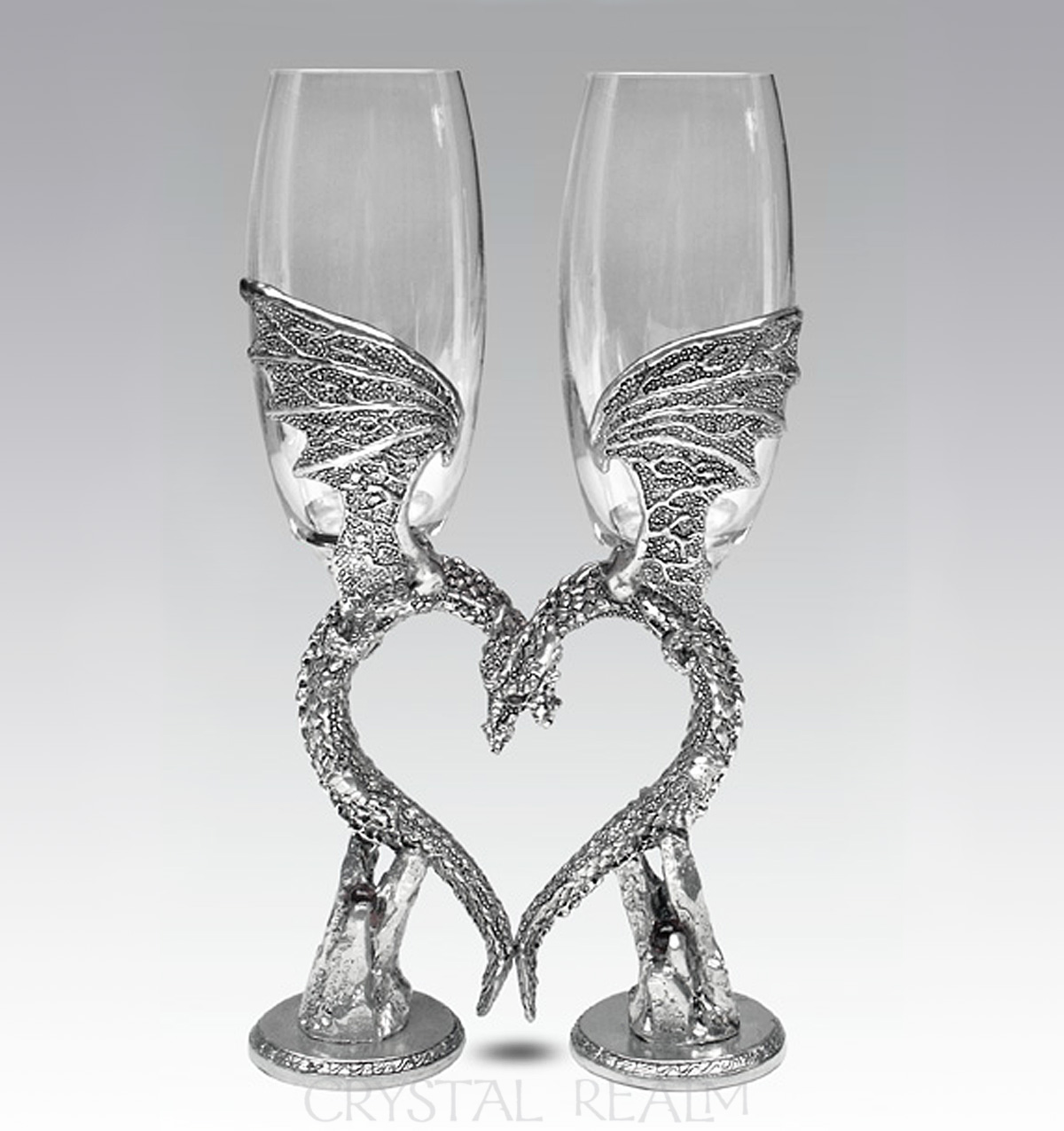 Clear toasting flutes with dragon wing heart stems