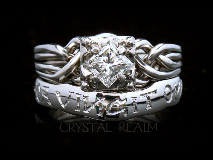 Guinevere puzzle ring with custom "amor vincit omnia" shadow band