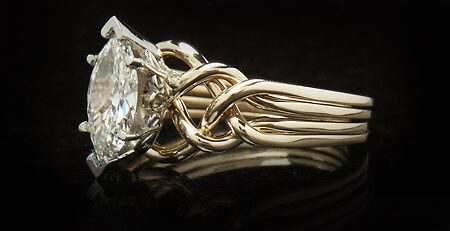 handwoven four piece puzzle ring with one carat marquise diamond